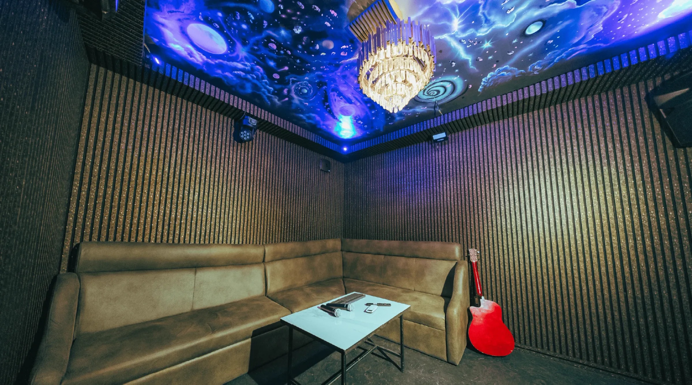 The Galaxy Room with a painted night-sky ceiling and chandelier