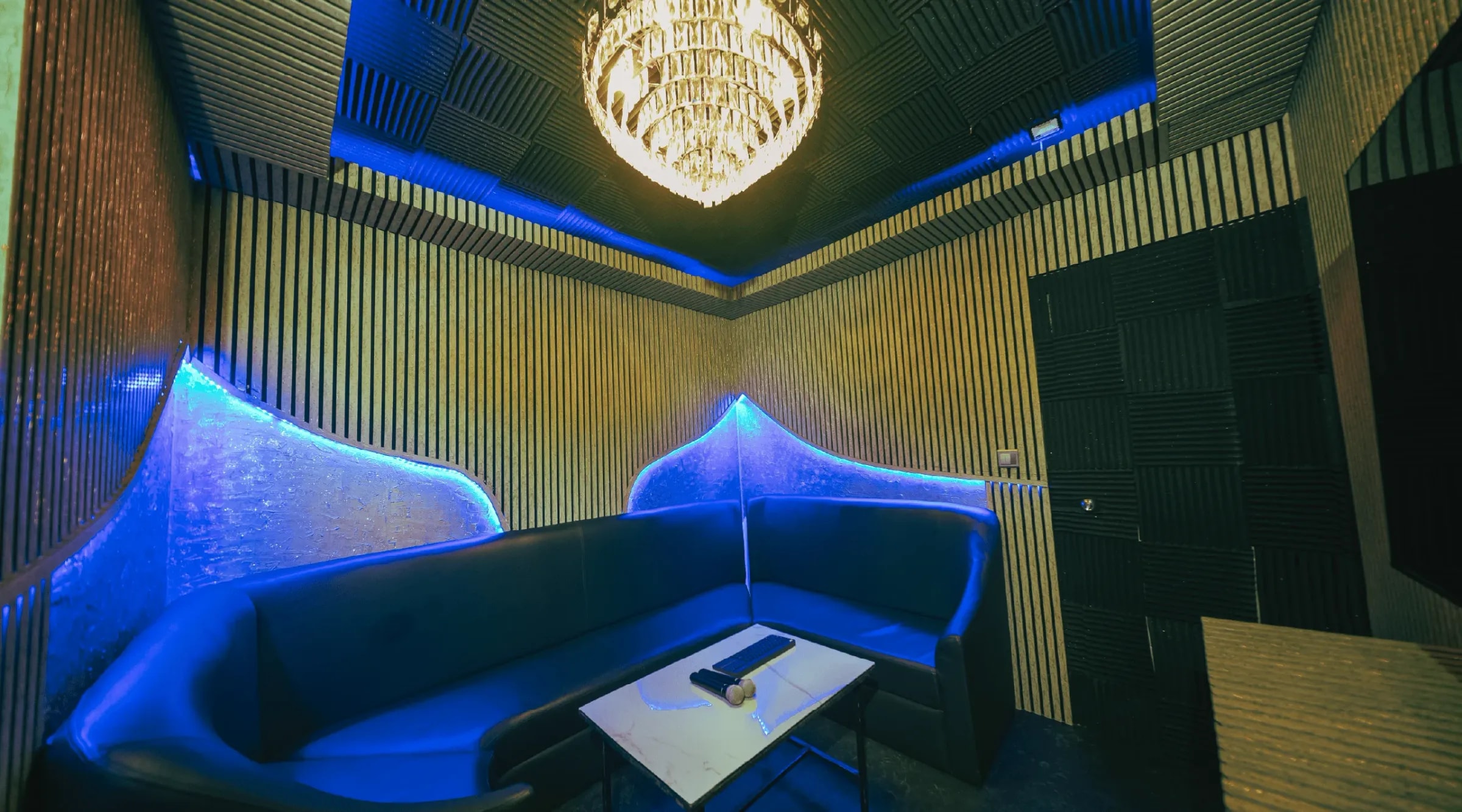The Royal Room with gold panelling, blue light and a chandelier